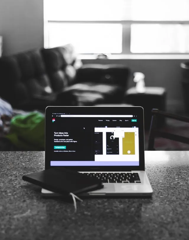 Laptop on a desk showing a website design
